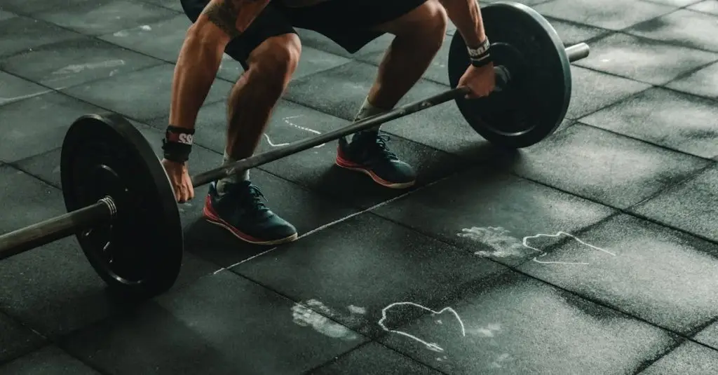 A muscular man in a gym preparing to lift a heavy barbell, showcasing strength and fitness.